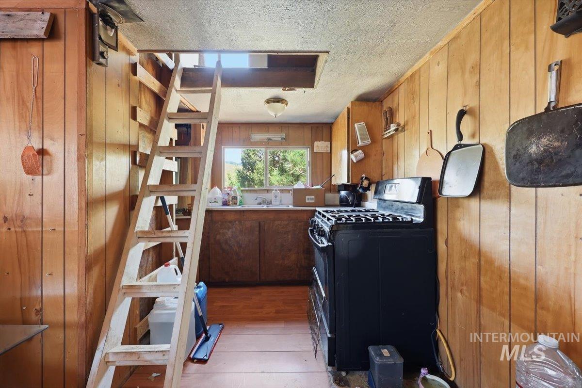 Wood-paneled interior featuring a ladder to an upper level