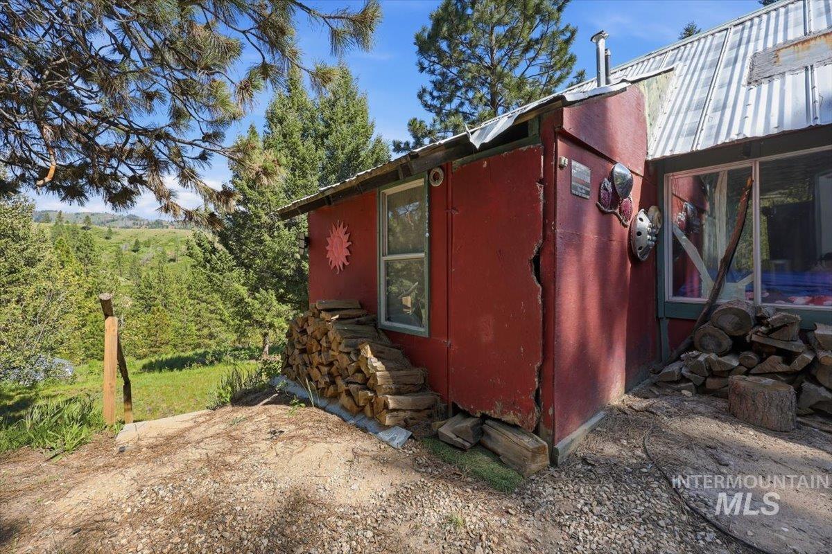 Red siding structure with corrugated metal roofing