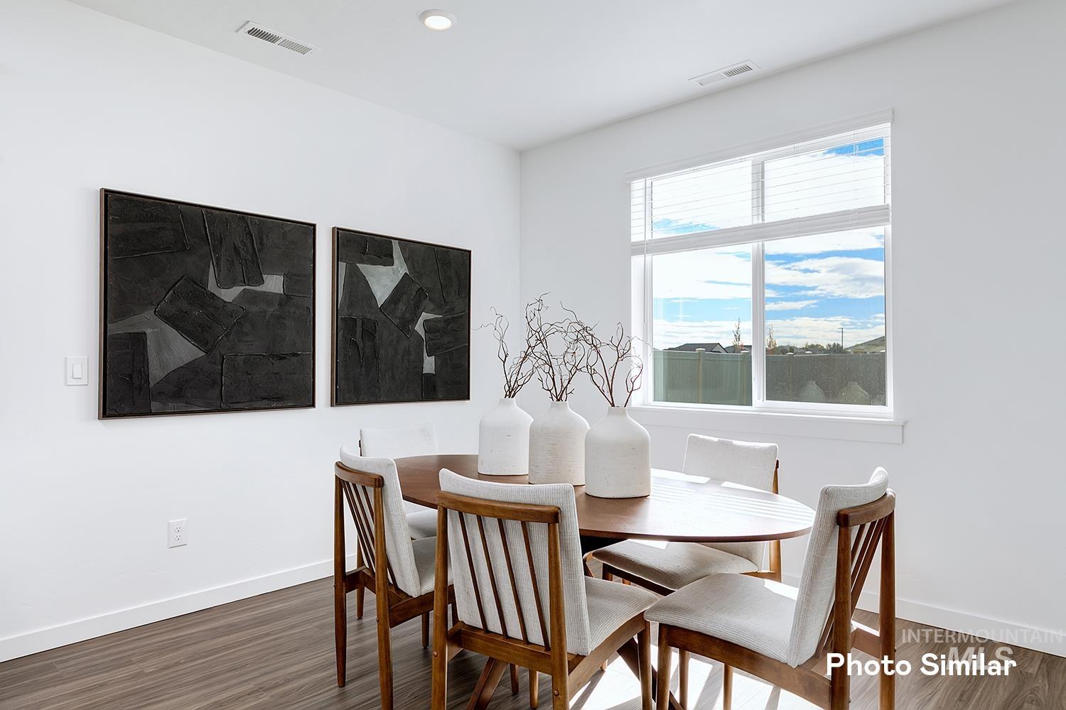Dining space featuring wood finished floors and recessed lighting