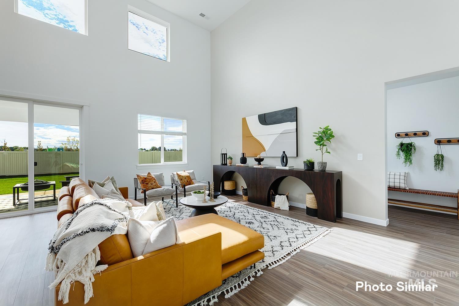 Living area with a towering ceiling and wood finished floors