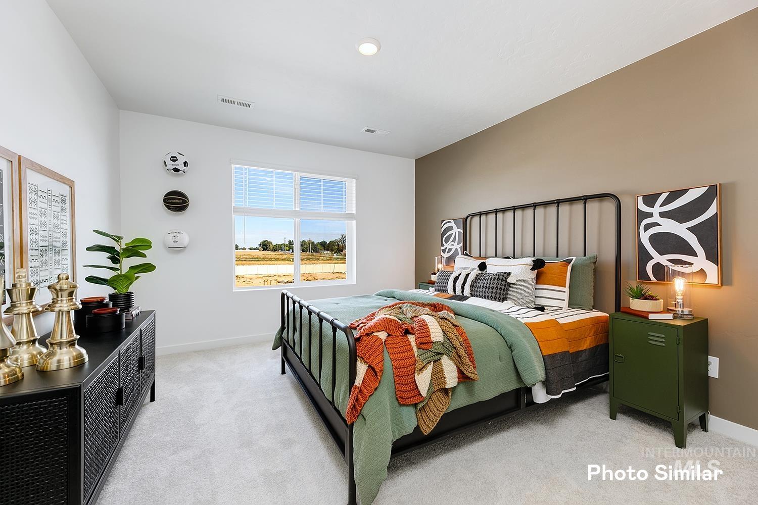 Bedroom featuring light colored carpet and baseboards