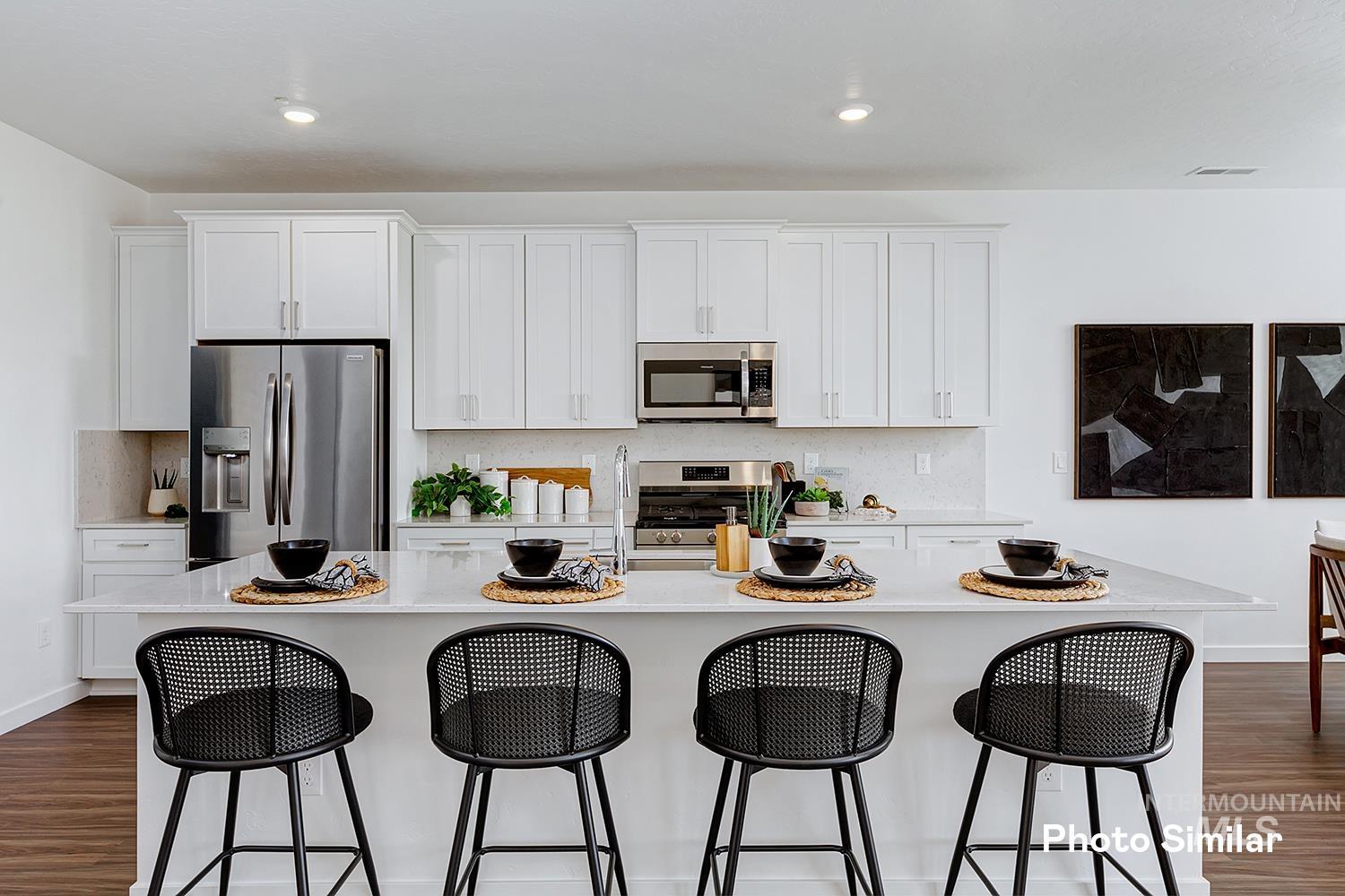 Kitchen featuring dark wood finished floors, white cabinetry, backsplash, appliances with stainless steel finishes, and recessed lighting