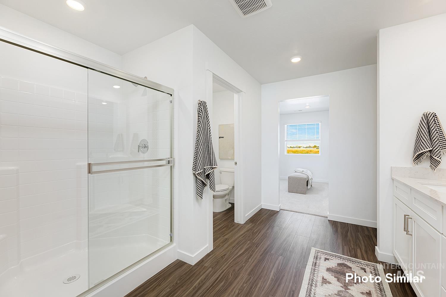 Full bathroom with vanity, a shower stall, dark wood-style floors, and recessed lighting