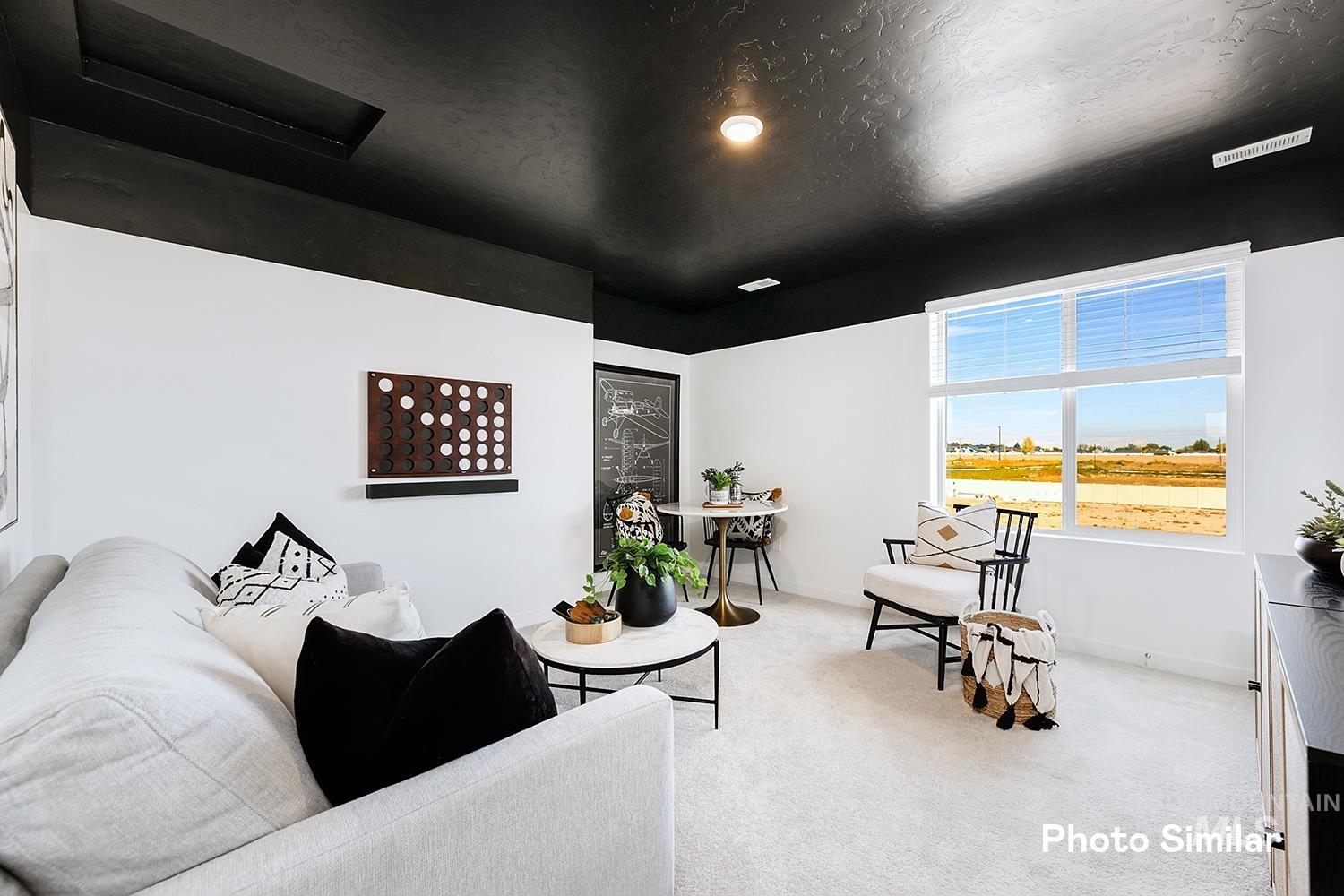 Living room featuring carpet, a textured ceiling, and recessed lighting