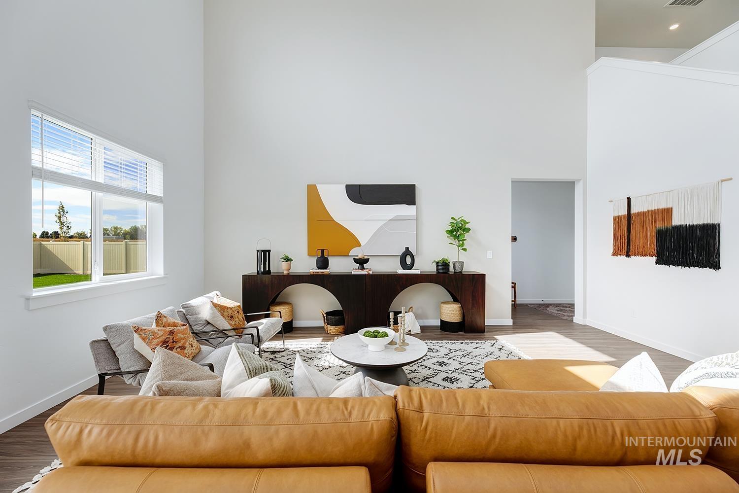 Living area with a high ceiling and wood finished floors