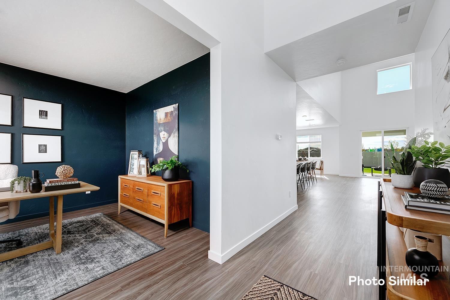 Office featuring wood finished floors and a high ceiling