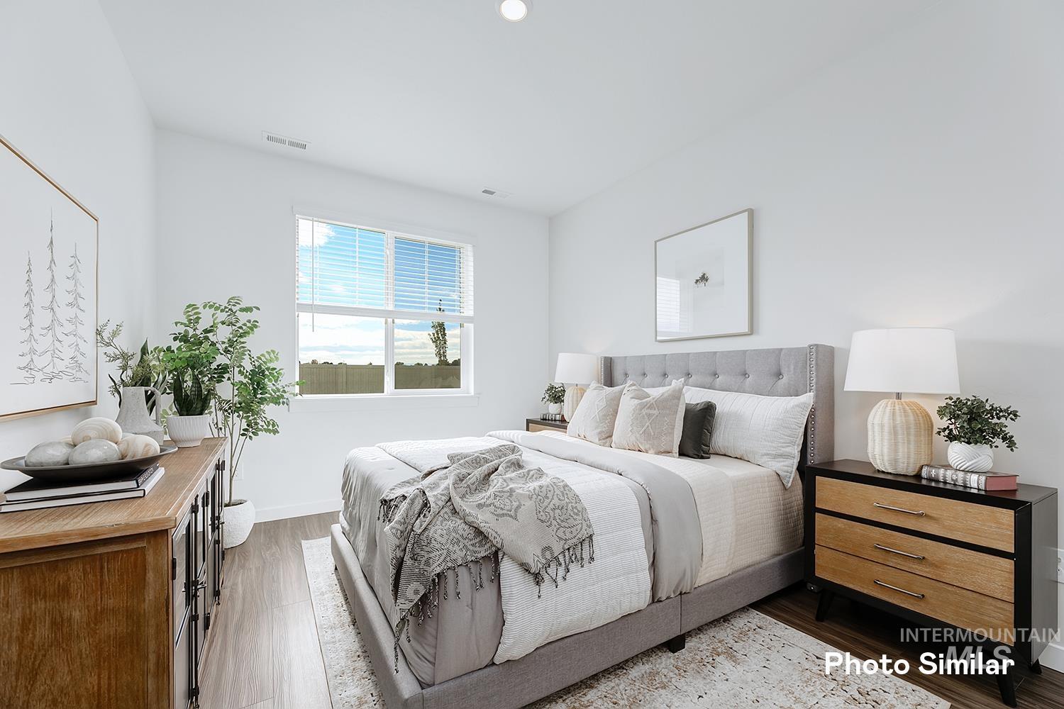 Bedroom featuring dark wood finished floors and baseboards