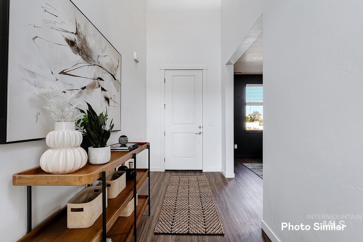 Foyer featuring dark wood-style floors and baseboards