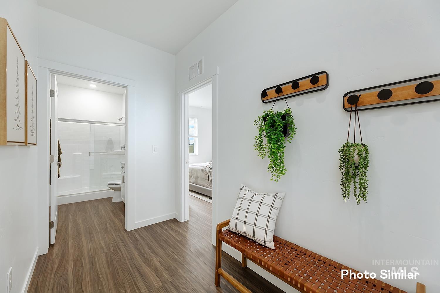 Hallway with dark wood finished floors and baseboards