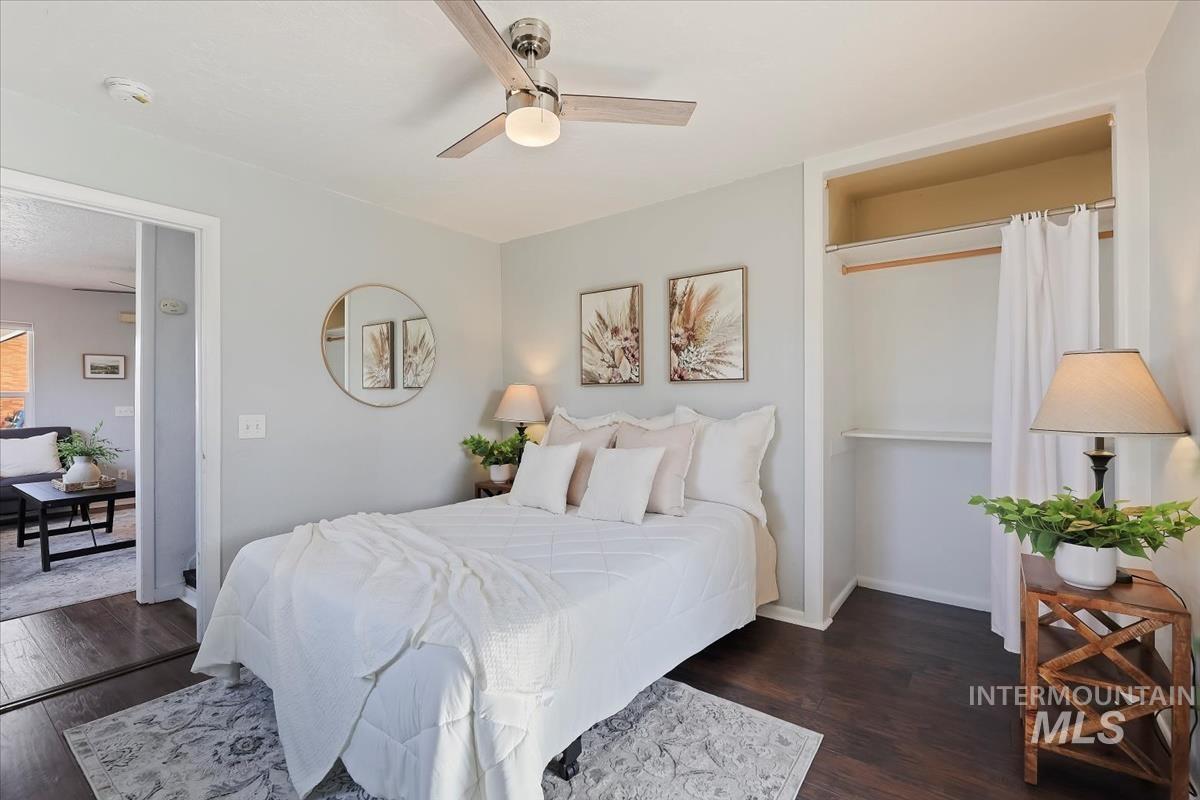 Bedroom with dark wood-style flooring and a ceiling fan