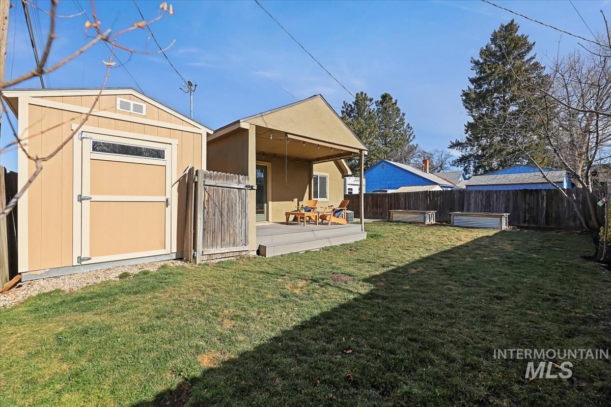 Back of property with a fenced backyard and a storage shed