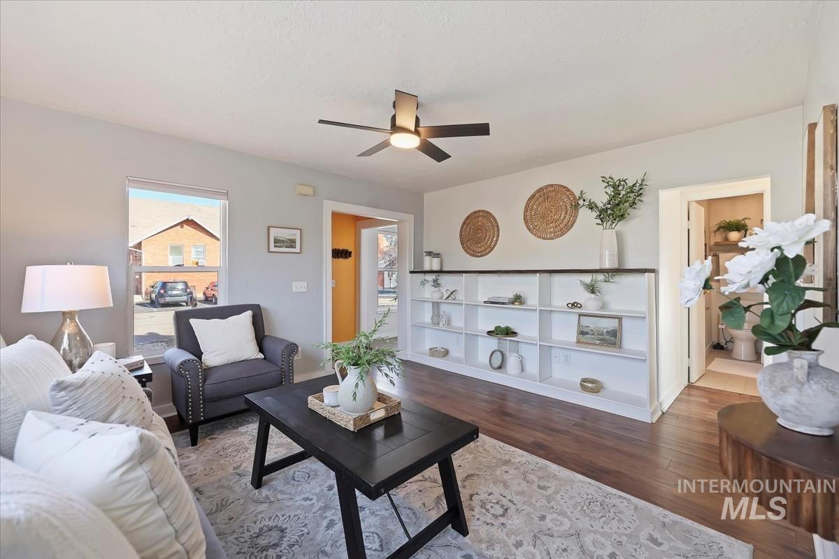 Living area with wood finished floors and a ceiling fan