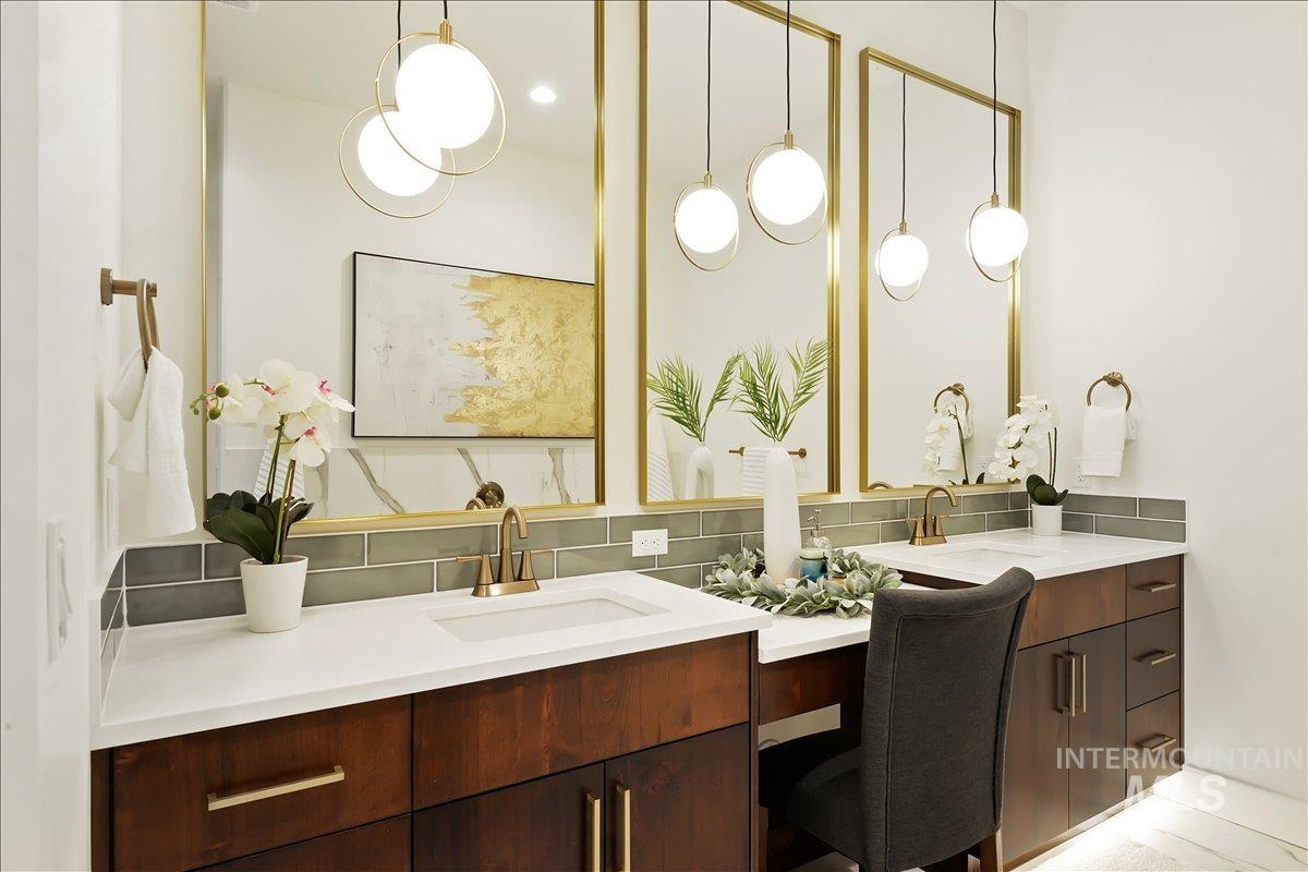 Full bath featuring backsplash and double vanity