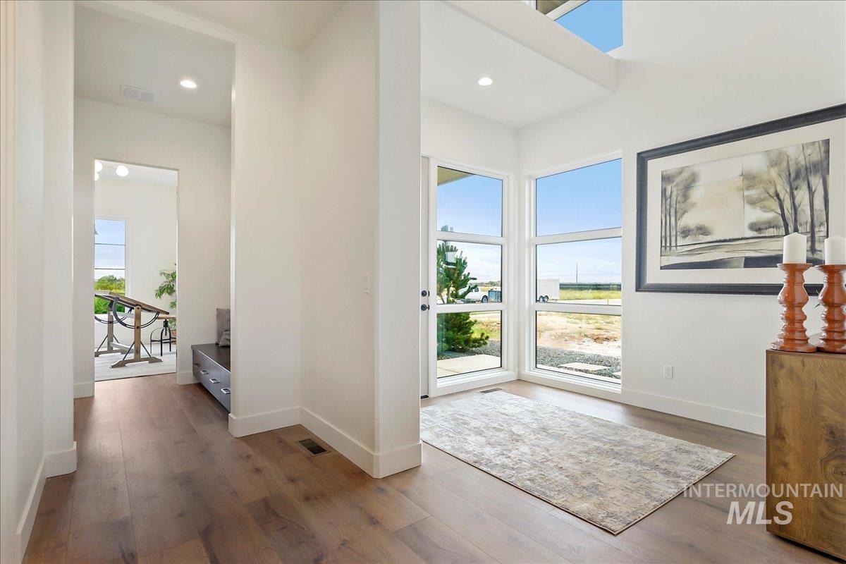 Doorway featuring wood finished floors and recessed lighting