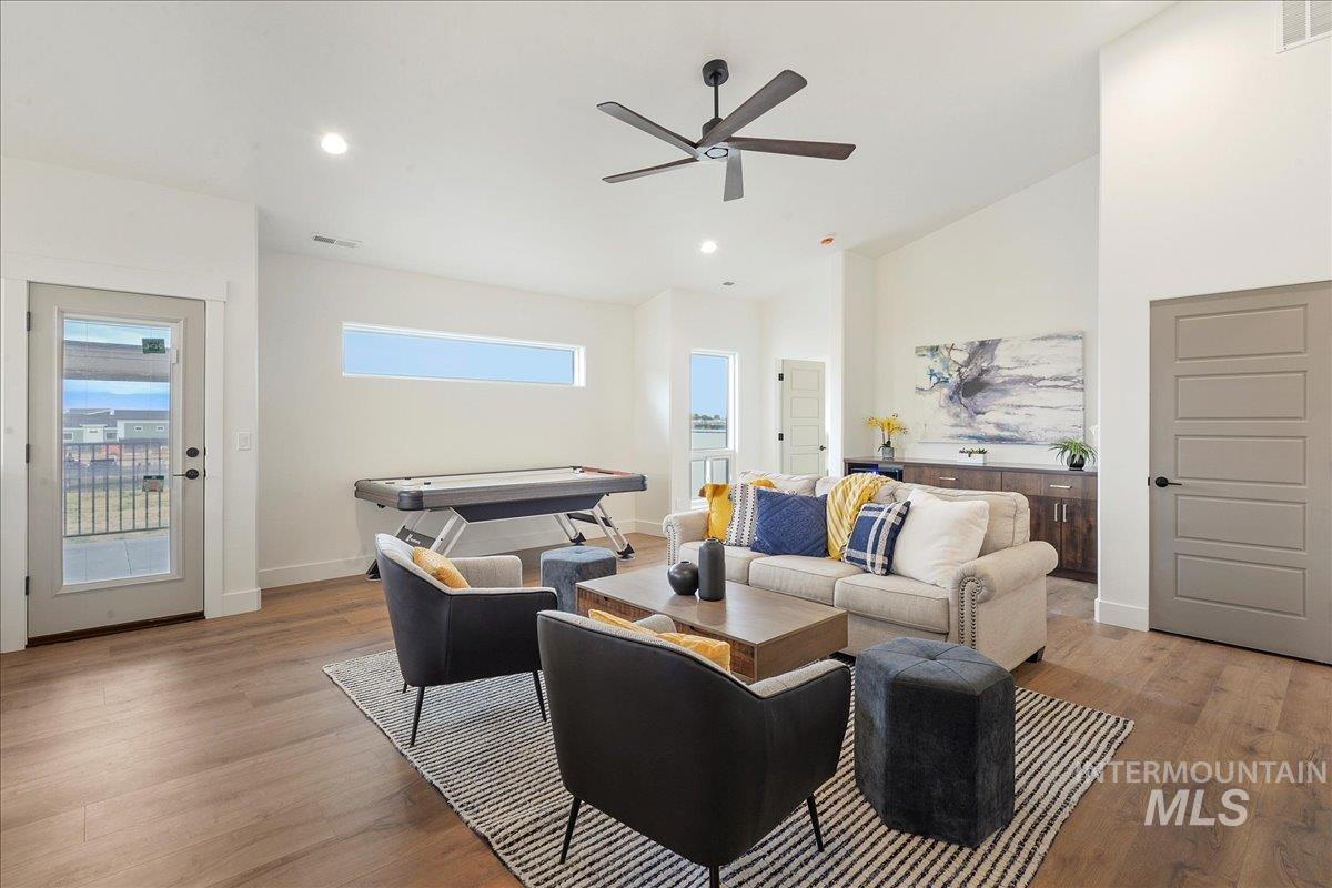 Living area with light wood-style floors, recessed lighting, a ceiling fan, billiards table, and high vaulted ceiling