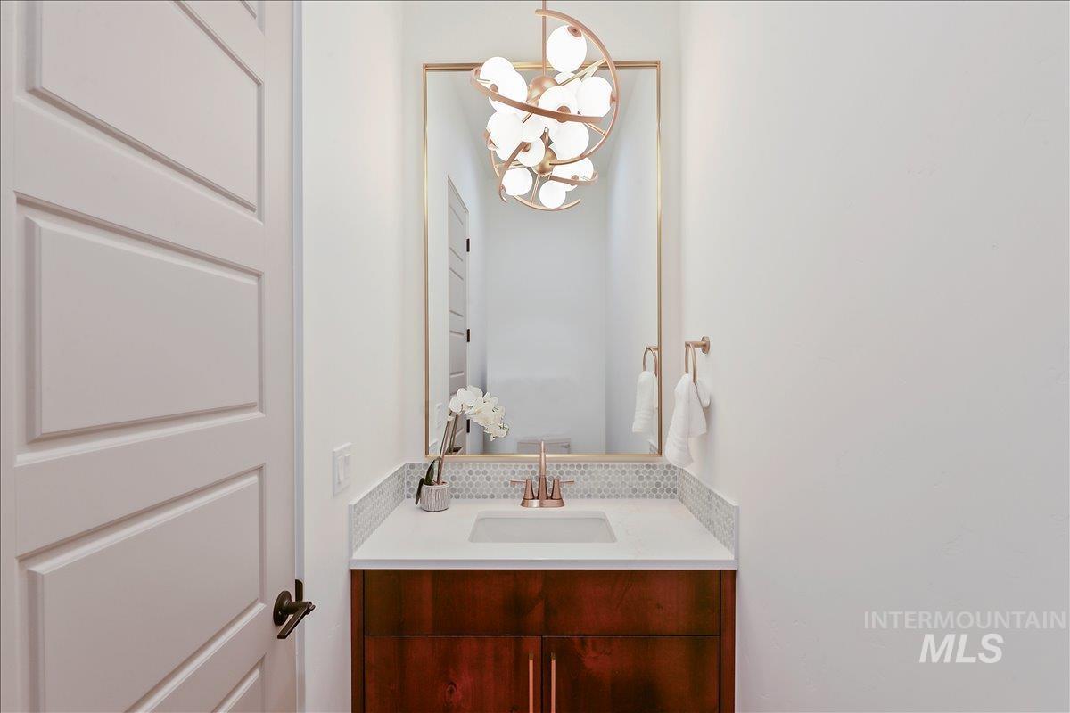 Bathroom featuring vanity and a chandelier