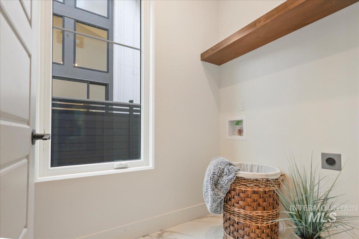 Washroom with hookup for a washing machine and hookup for an electric dryer