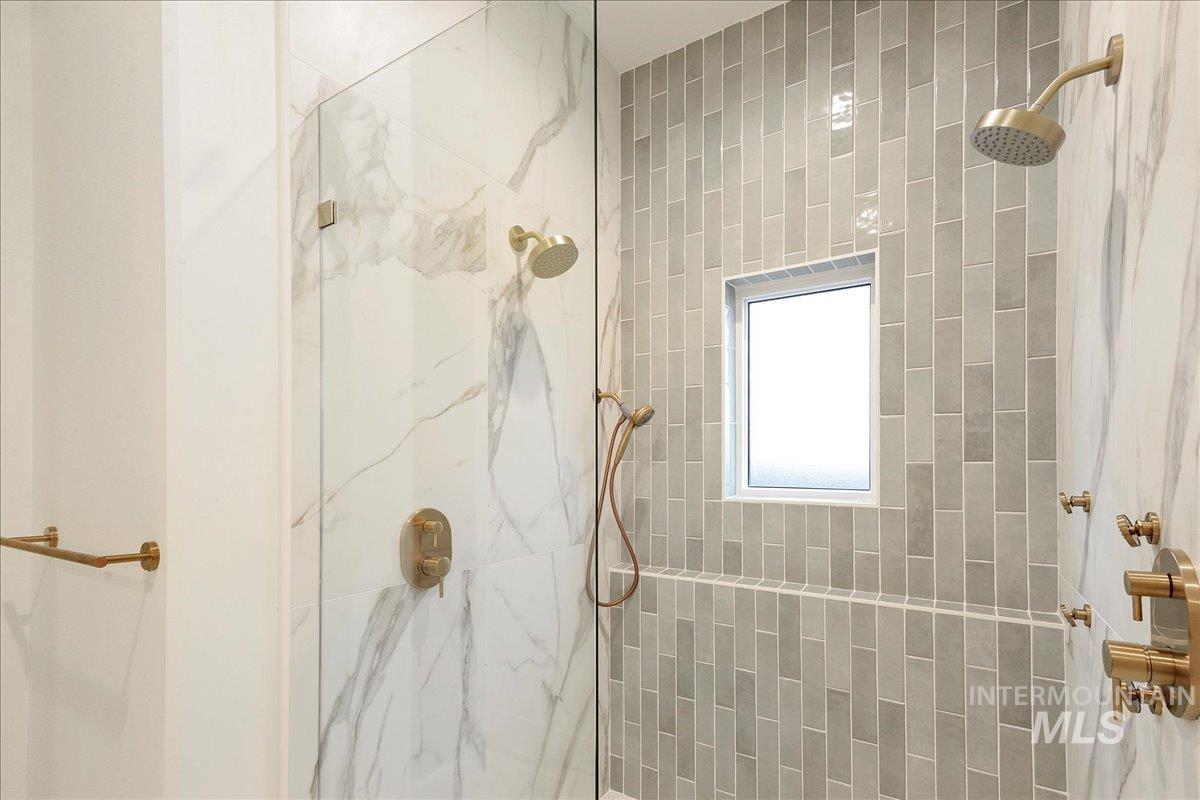 Bathroom with a marble finish shower