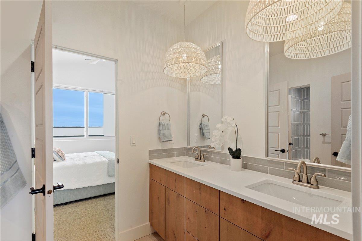 Ensuite bathroom with double vanity and a chandelier
