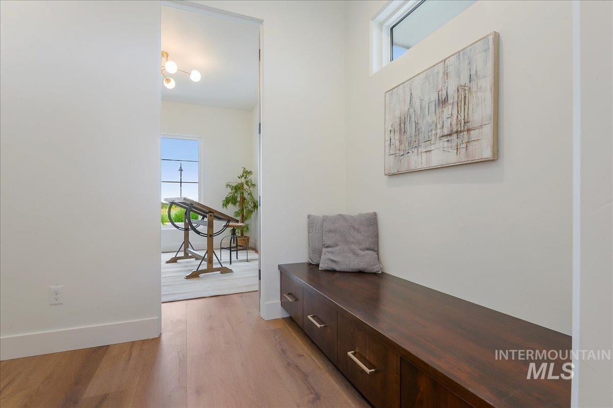 Corridor featuring light wood-style floors and baseboards
