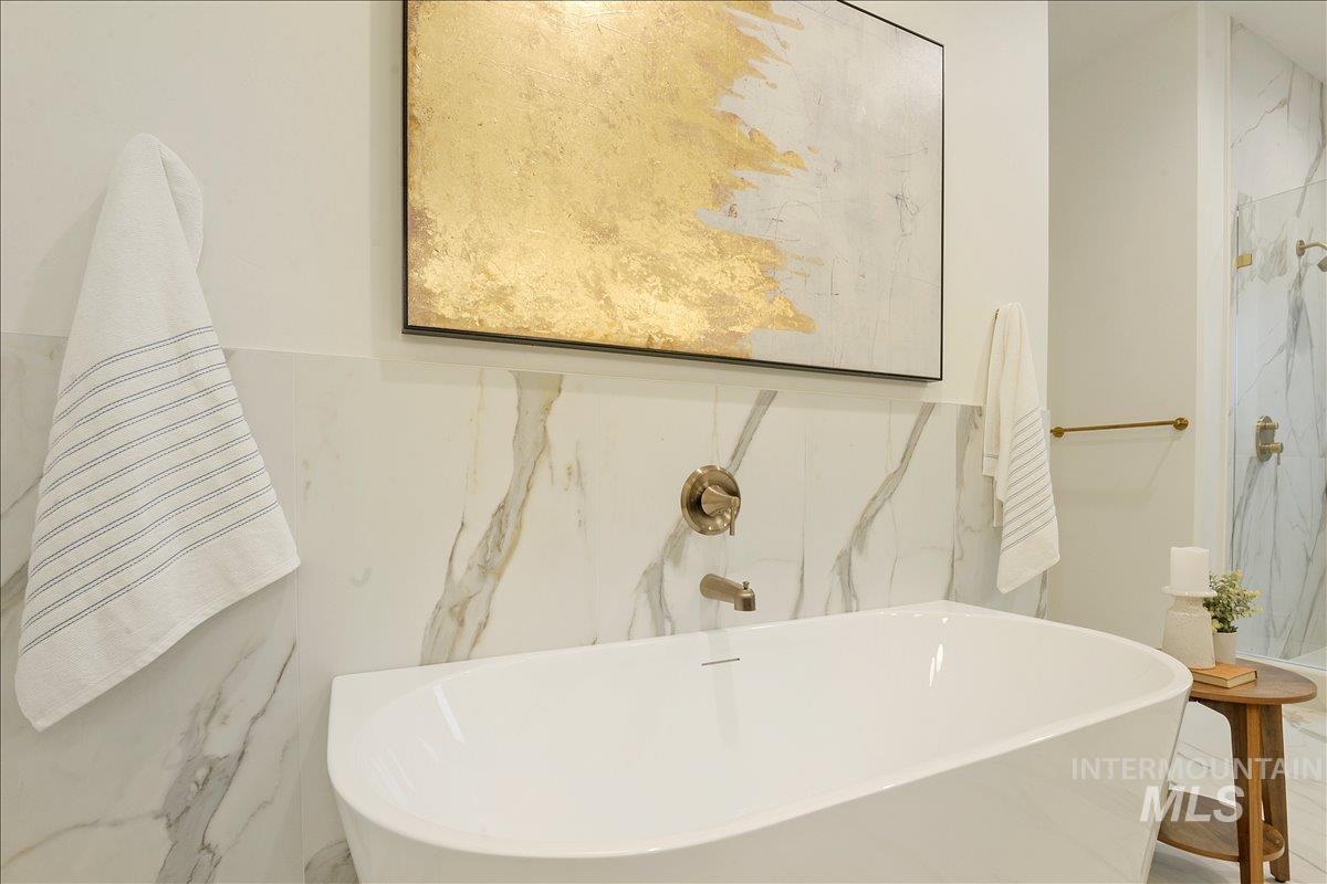 Bathroom view of a soaking tub and tile walls