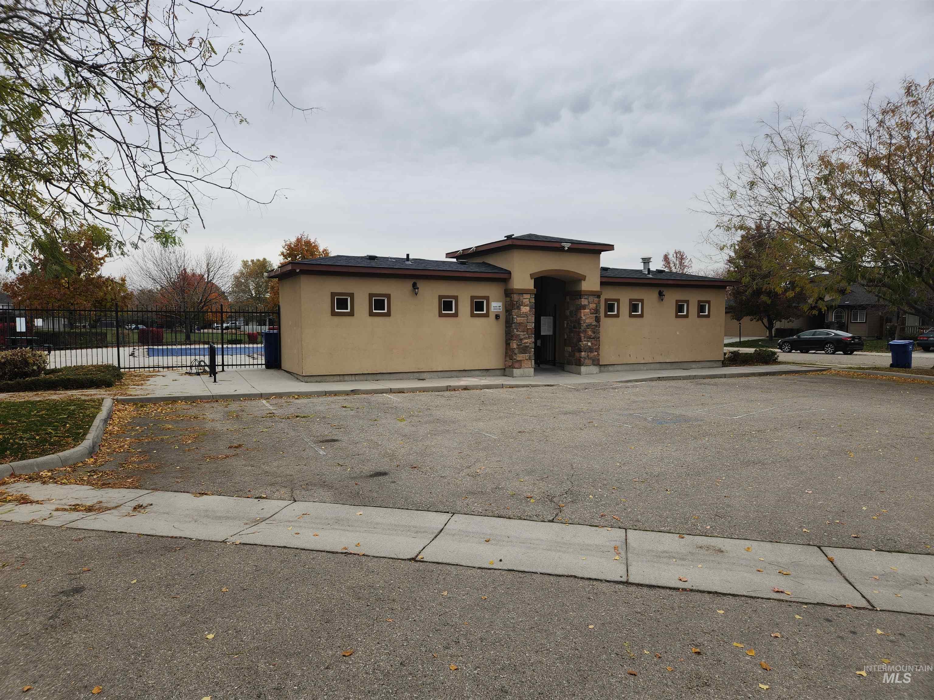 View of front of house featuring stucco siding and stone siding