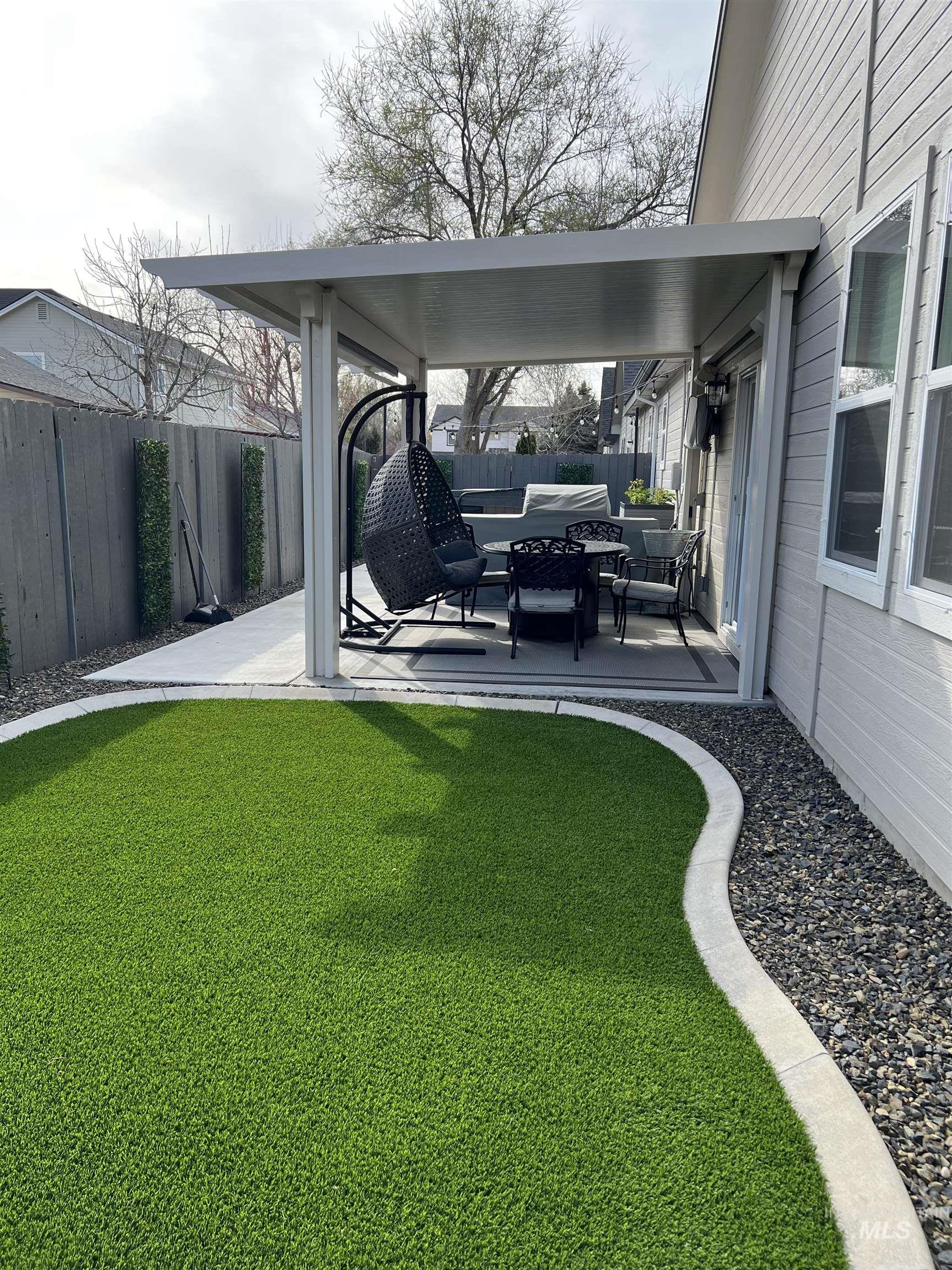 Fenced backyard with a patio area and an outdoor hangout area
