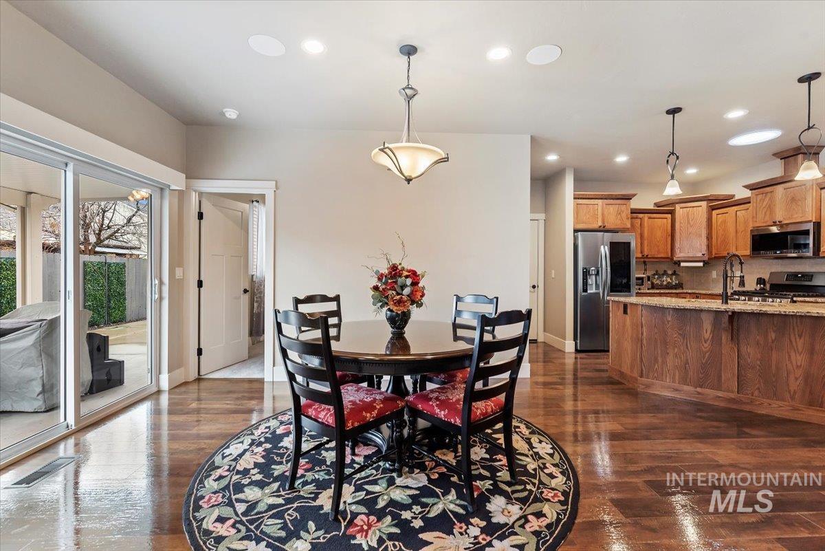 Dining room featuring dark wood-type flooring and recessed lighting