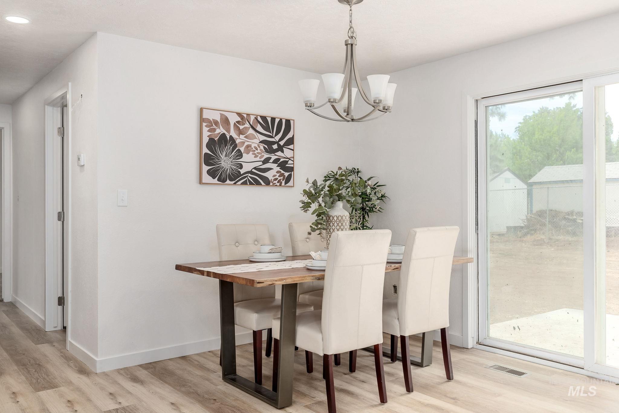 Dining space featuring light wood-style flooring, a chandelier, and recessed lighting