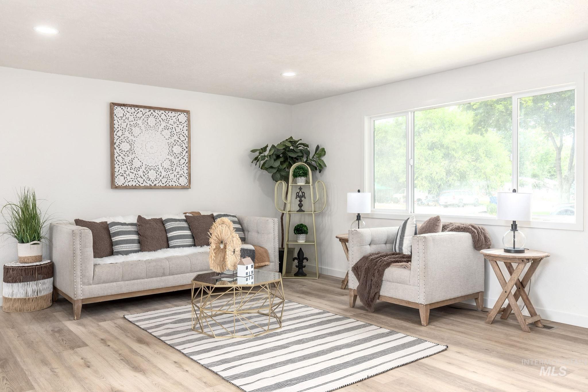 Living area featuring light wood finished floors and recessed lighting