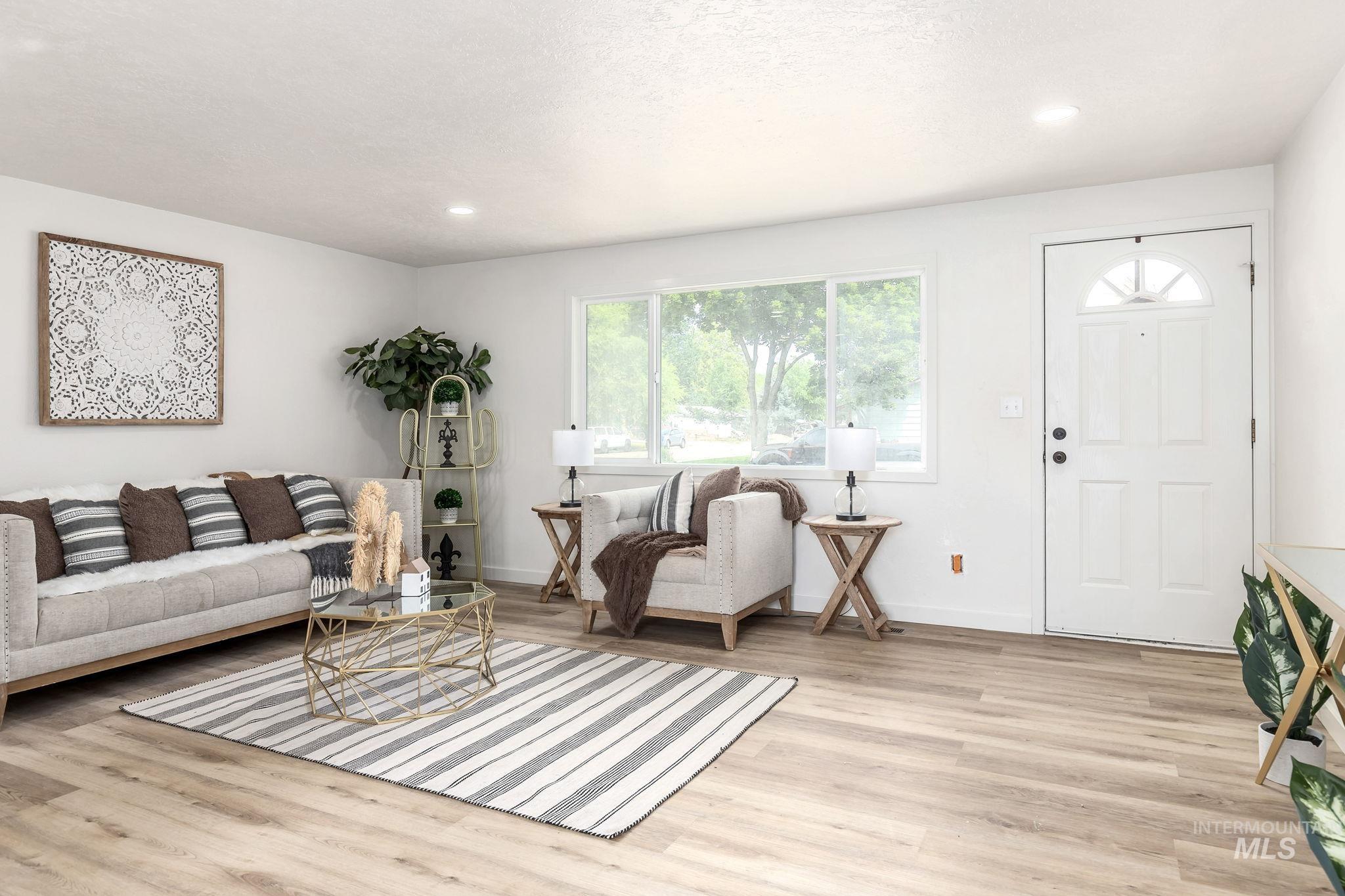 Living room featuring light wood finished floors and recessed lighting