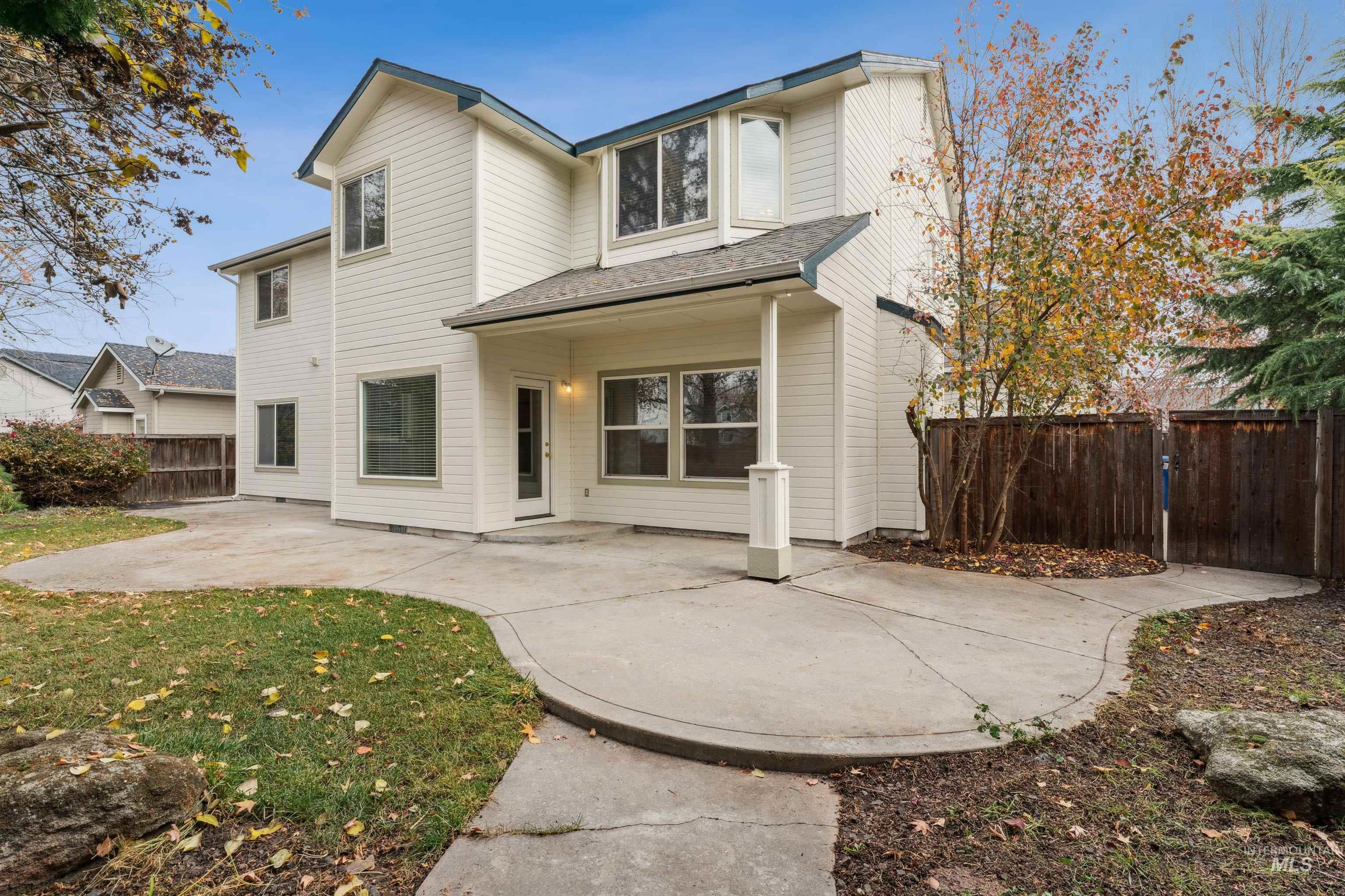 Rear view of property with a patio and roof with shingles