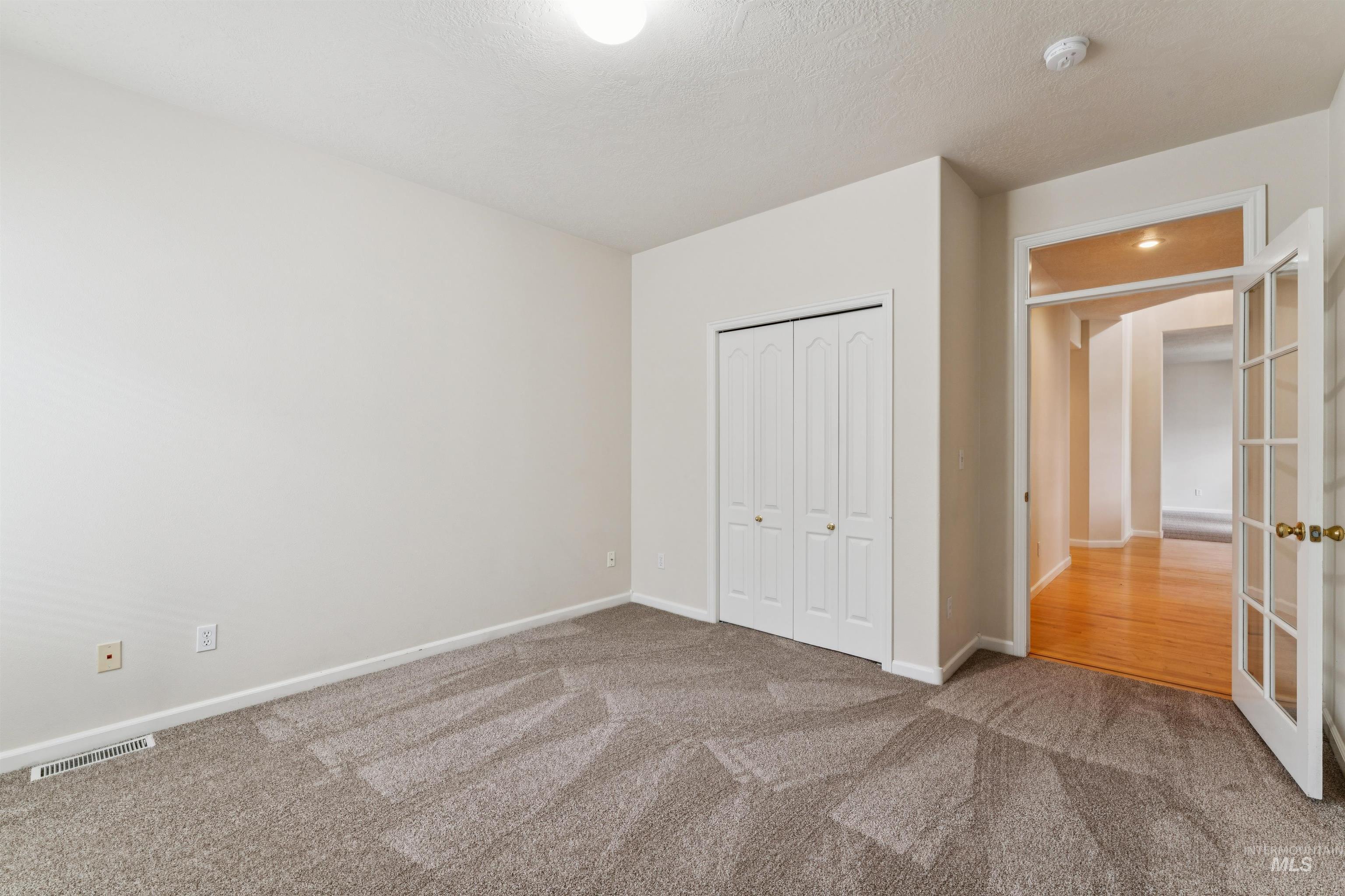 Unfurnished bedroom with a closet and carpet
