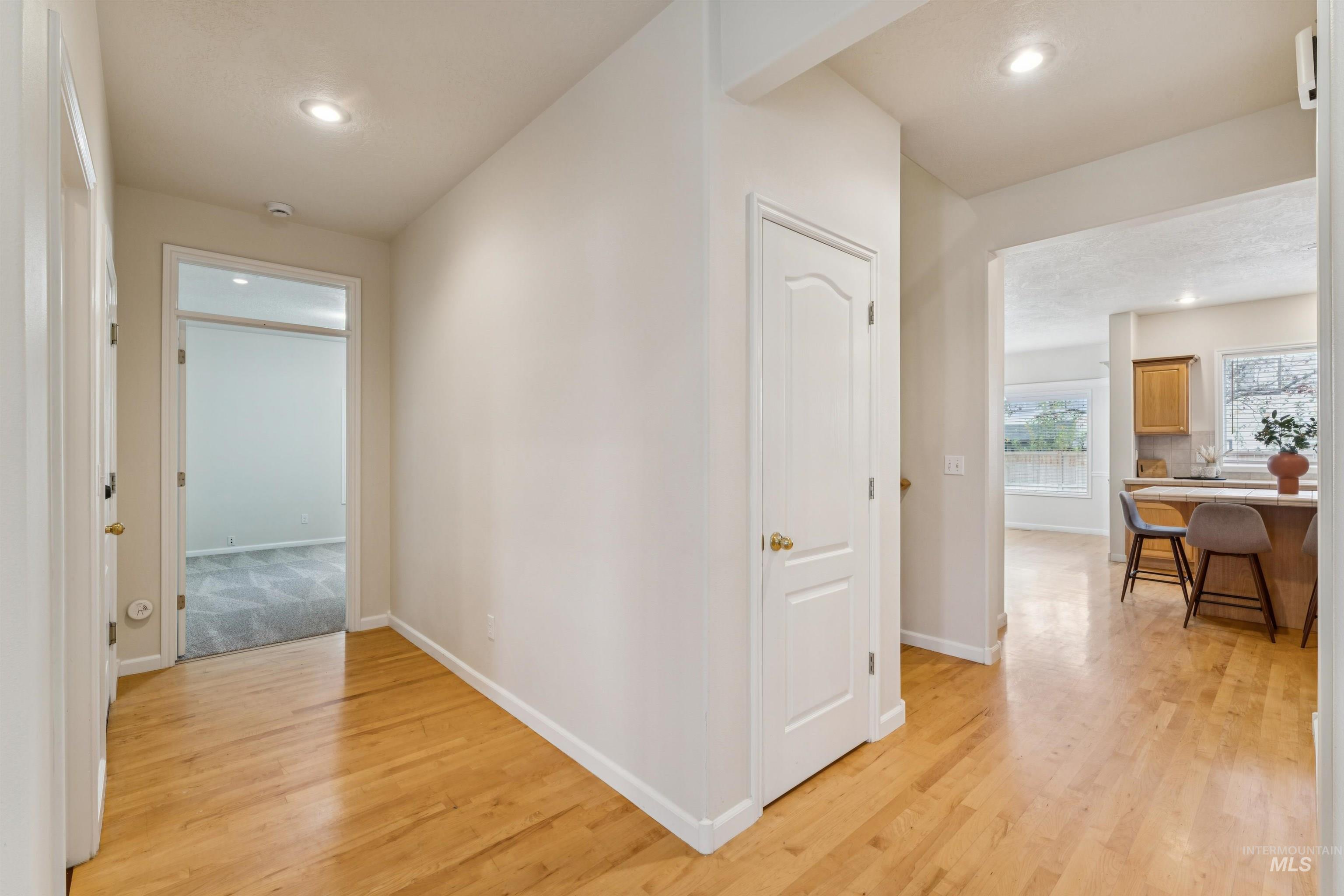 Hall featuring light wood-style floors and recessed lighting