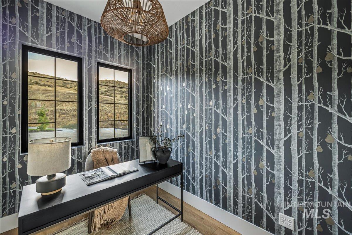 Office space featuring wood finished floors and a chandelier