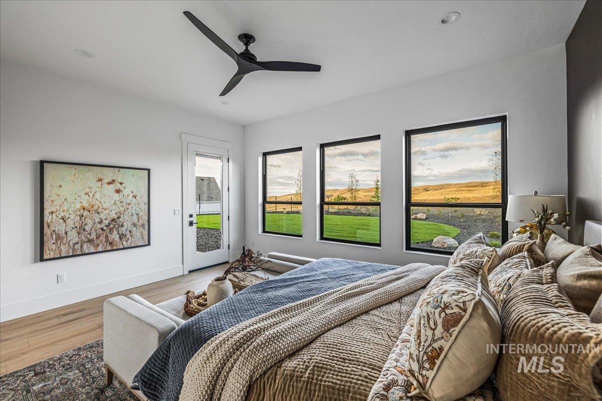 Bedroom featuring access to outside, ceiling fan, and wood finished floors