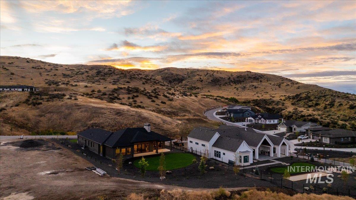 Aerial view of property and surrounding area with a mountain backdrop