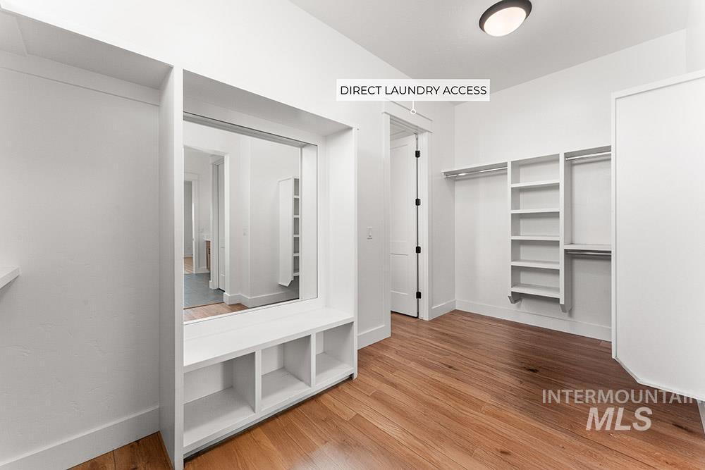 Walk in closet with wood finished floors