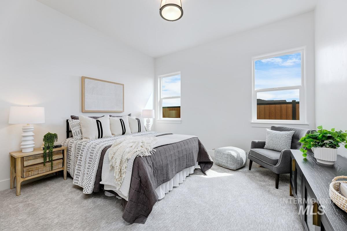 Bedroom featuring light colored carpet