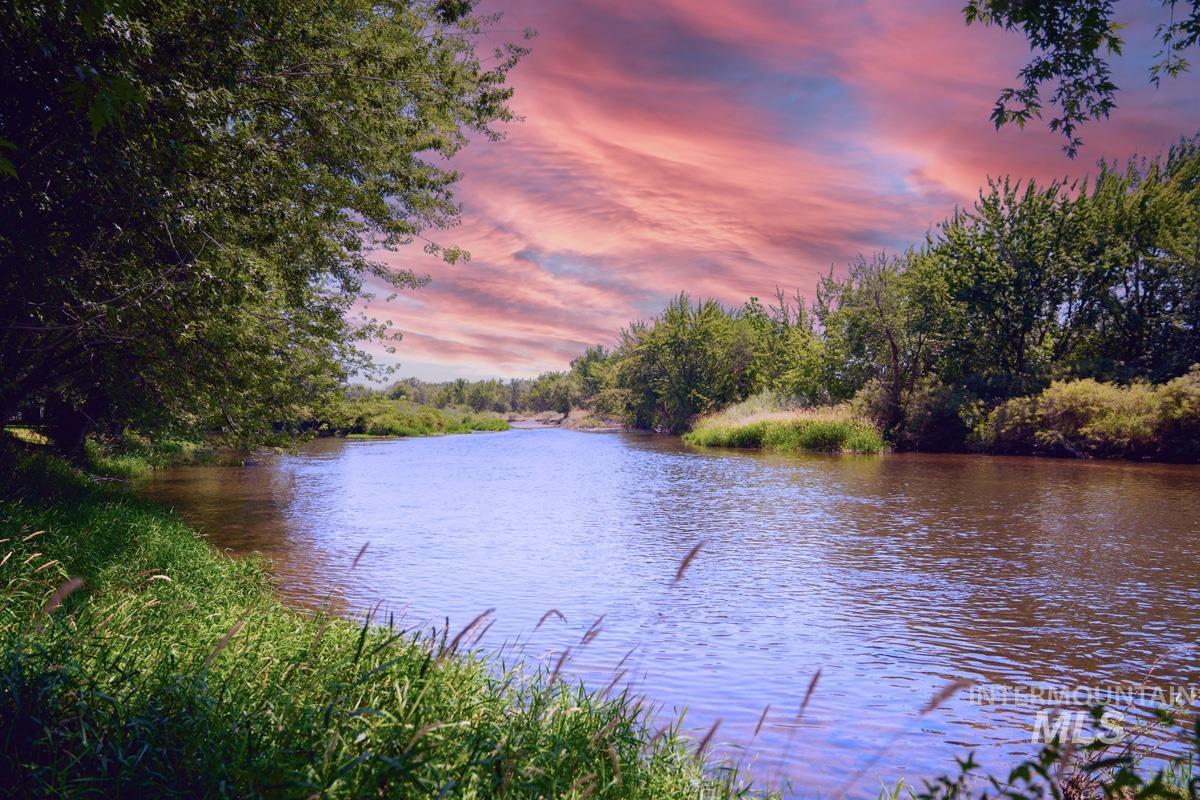 Water view with a heavily wooded area