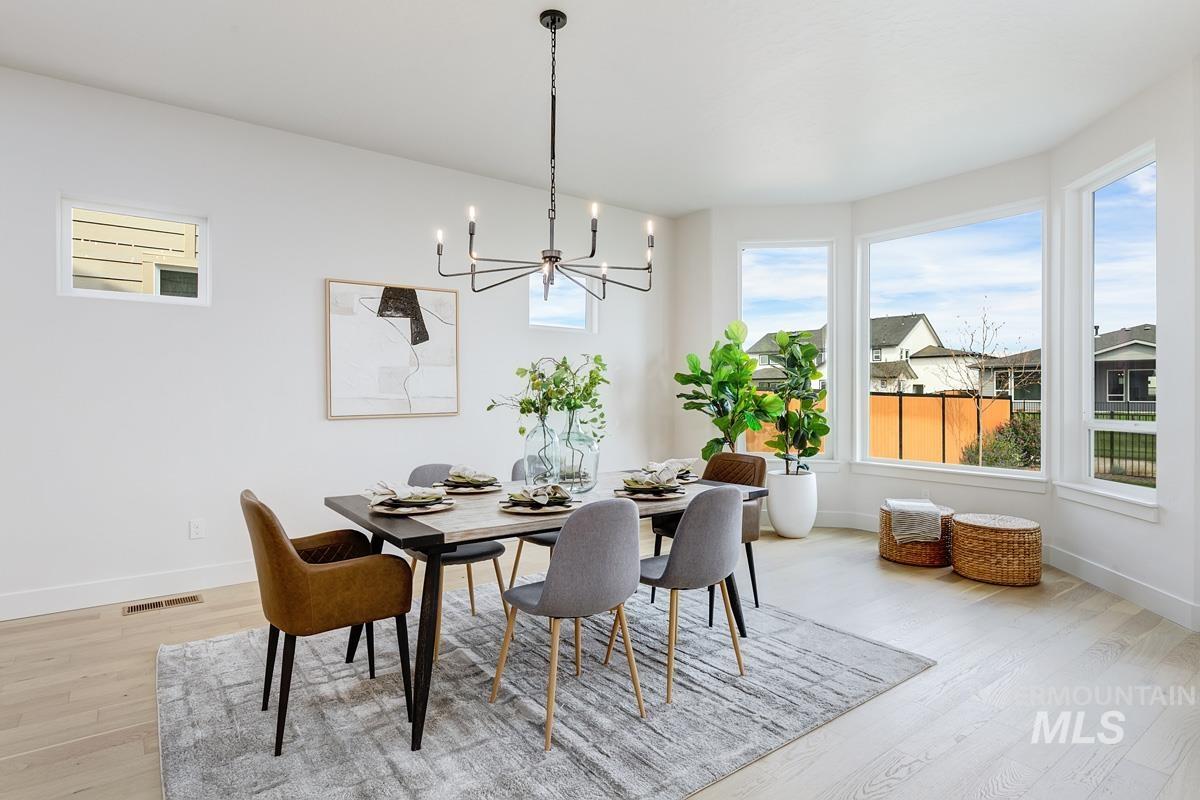 Dining area featuring light wood-style floors and a chandelier