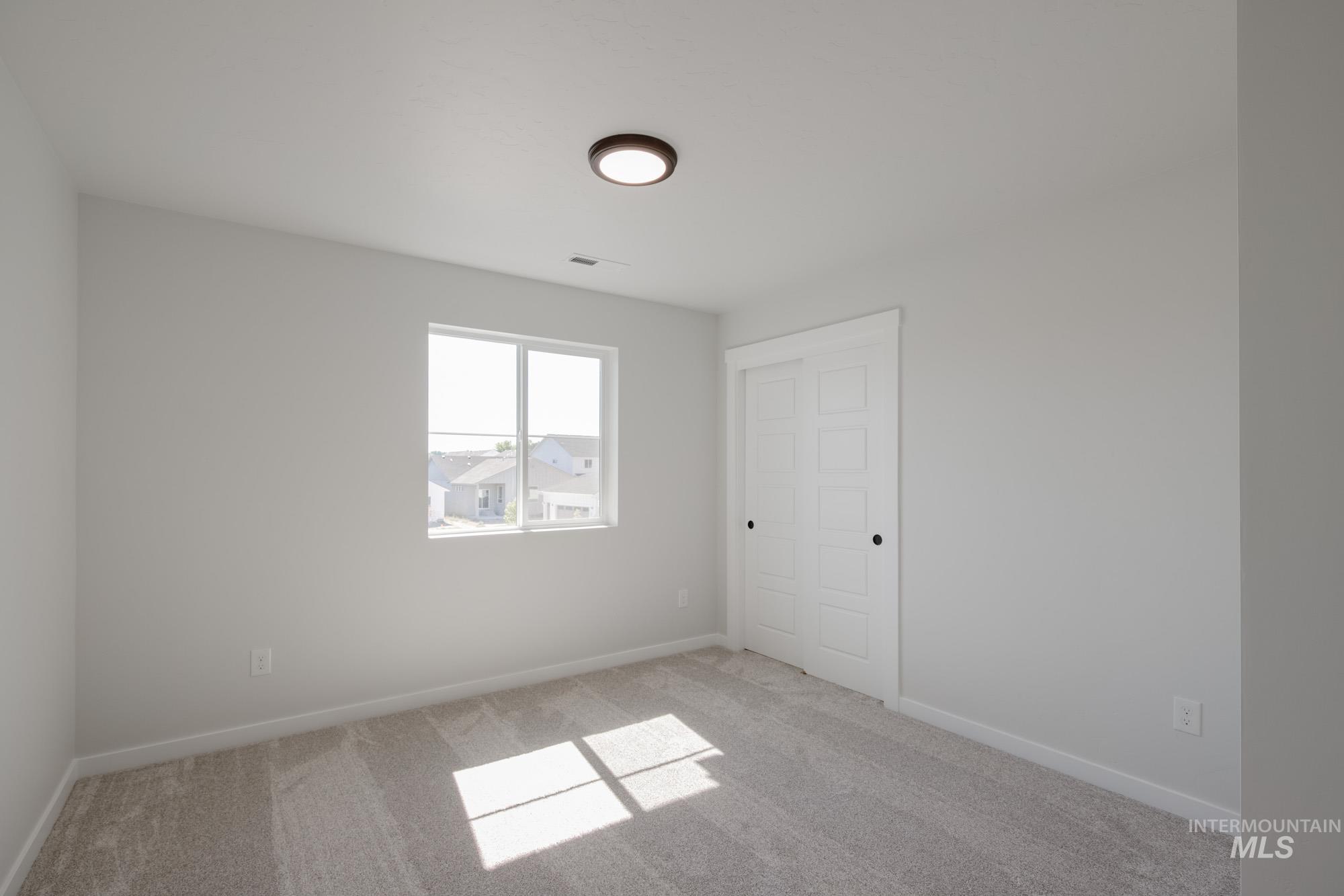 Spare room with light colored carpet