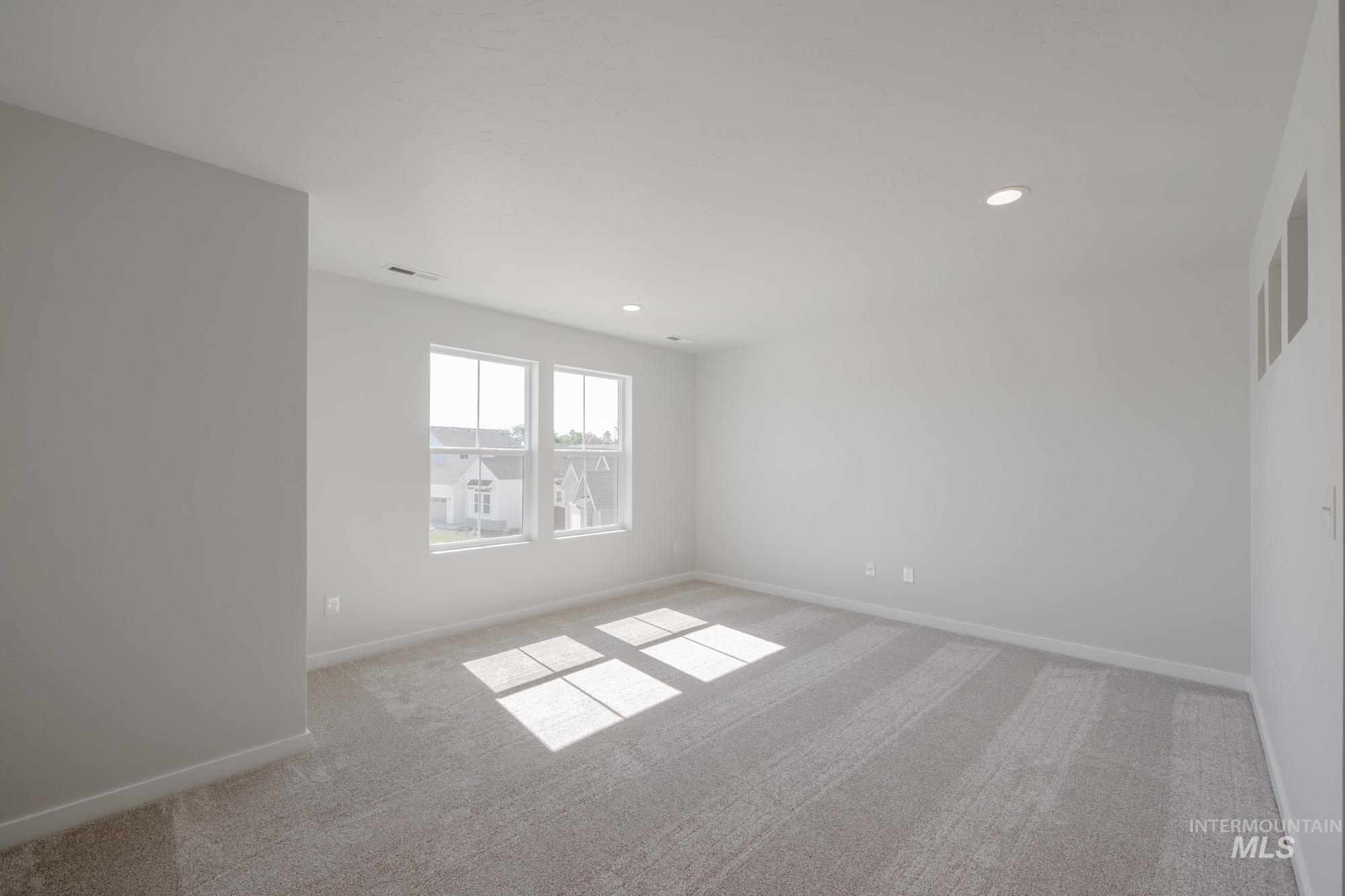 Unfurnished room with light carpet and recessed lighting