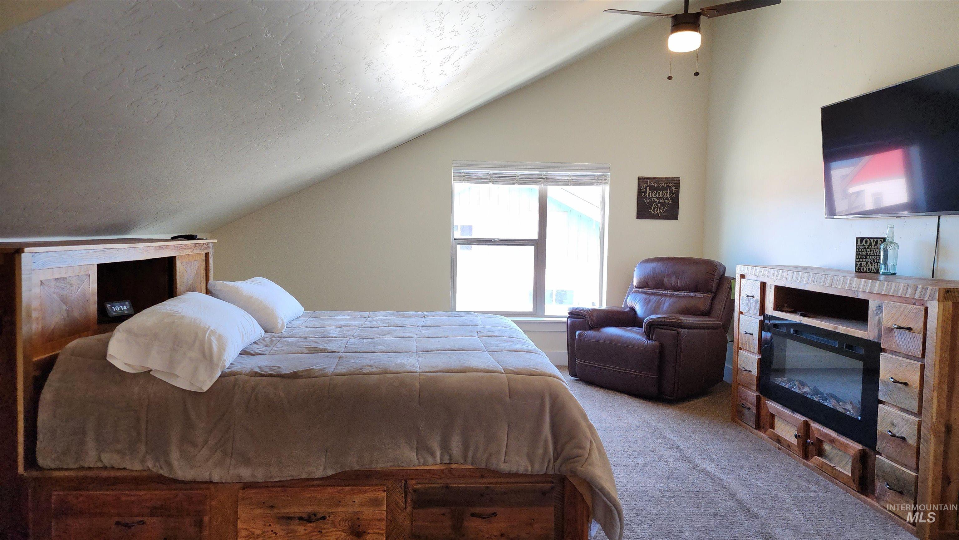 Custome made reclaimed wood furniture that fits with the ceiling slant allowing for maximum use of the space.  Infrared Fireplace Console, TV, large recliner.