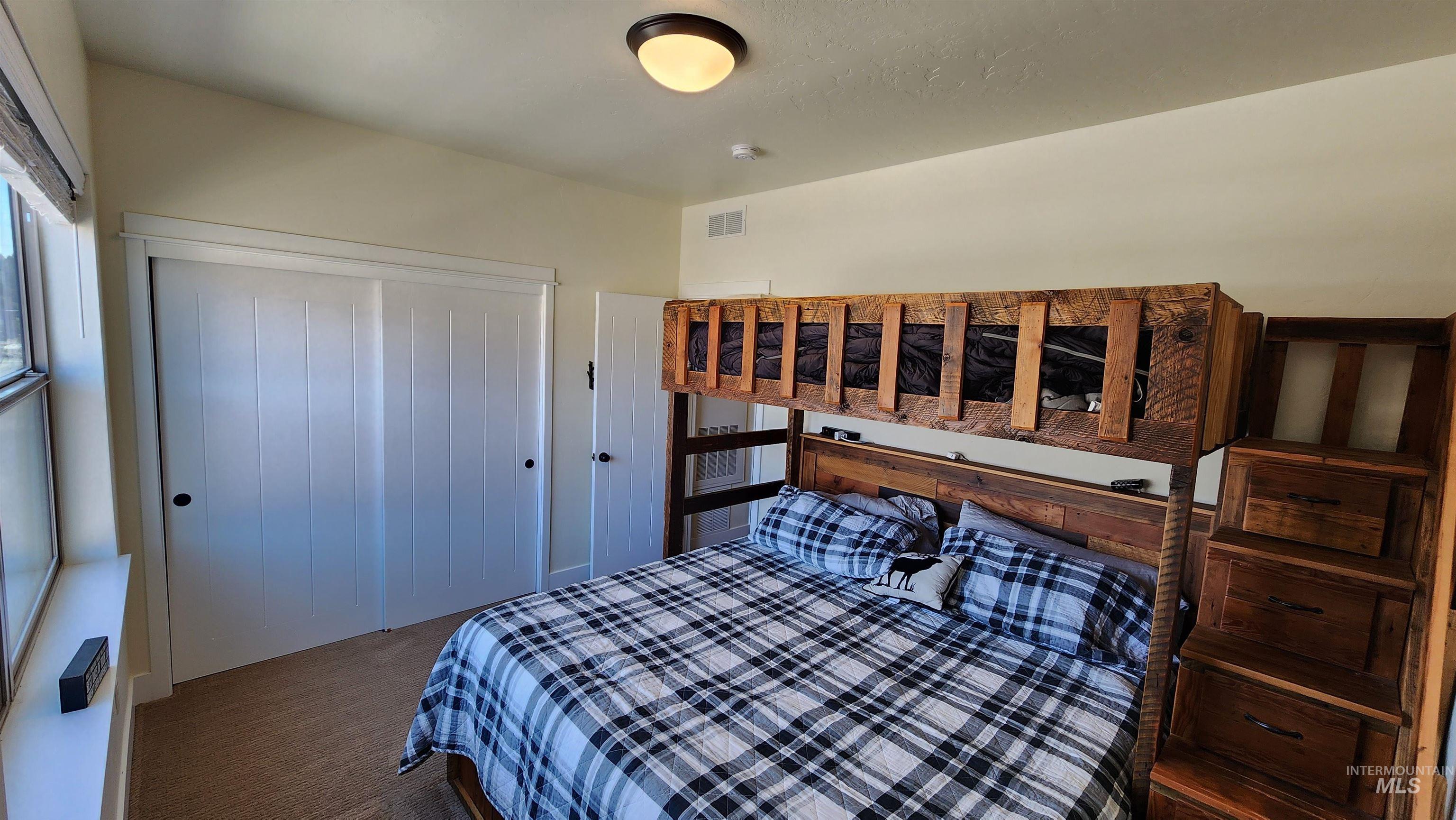 Custome reclaimed wood twin over king bunk bed with under bed storage as well as up the stairs.  Games included.