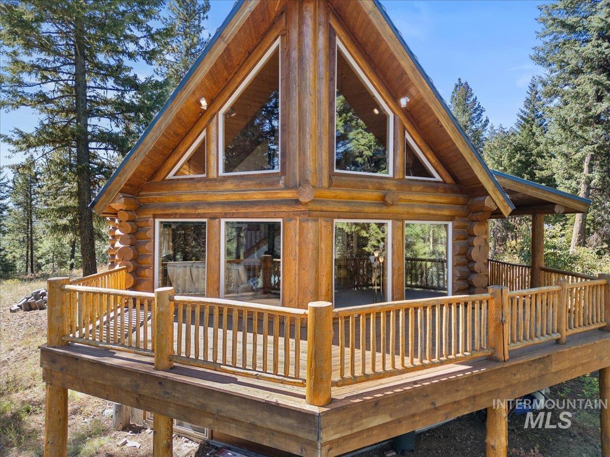 Rear view of property with log siding and a deck