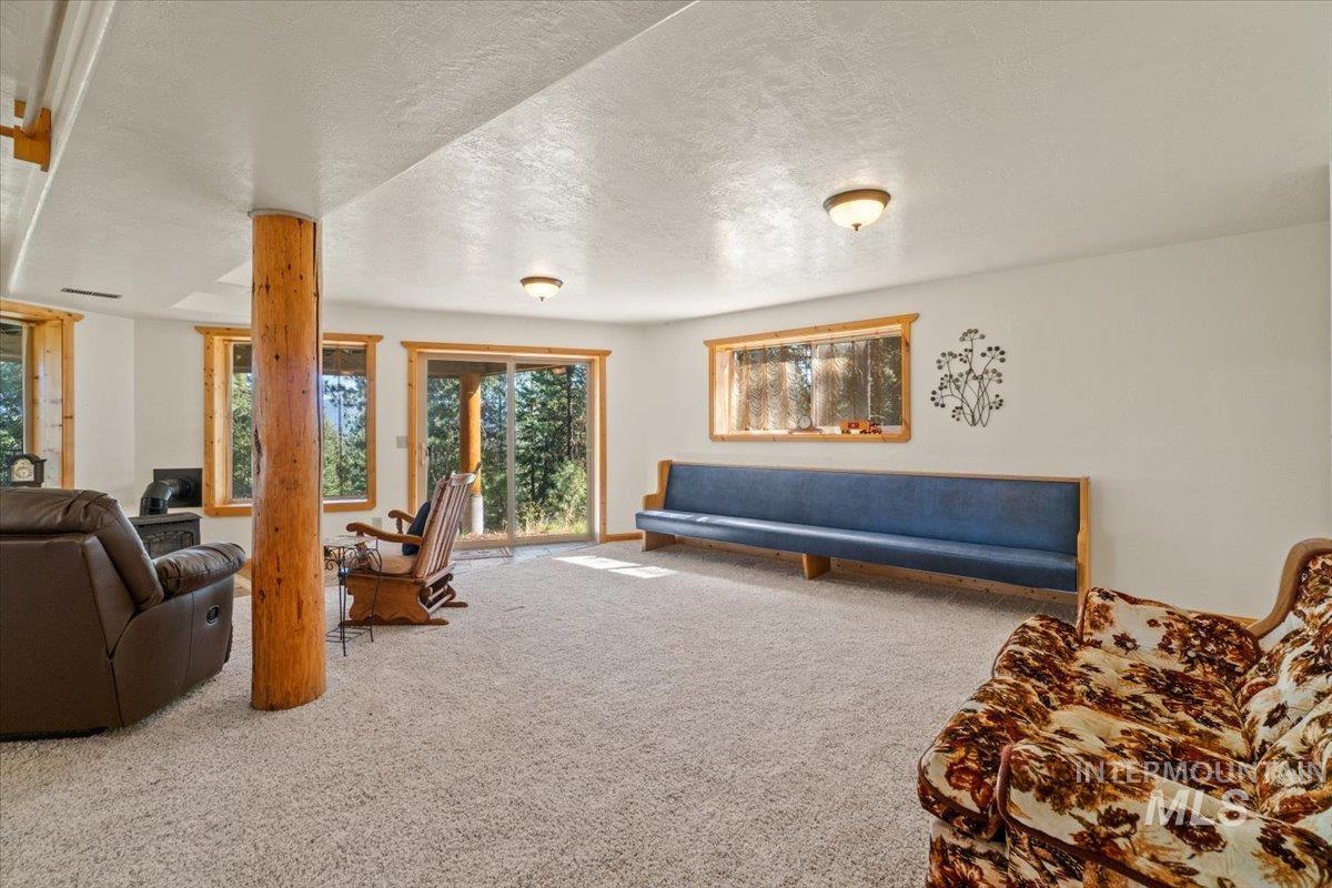 Living room featuring carpet floors and a textured ceiling