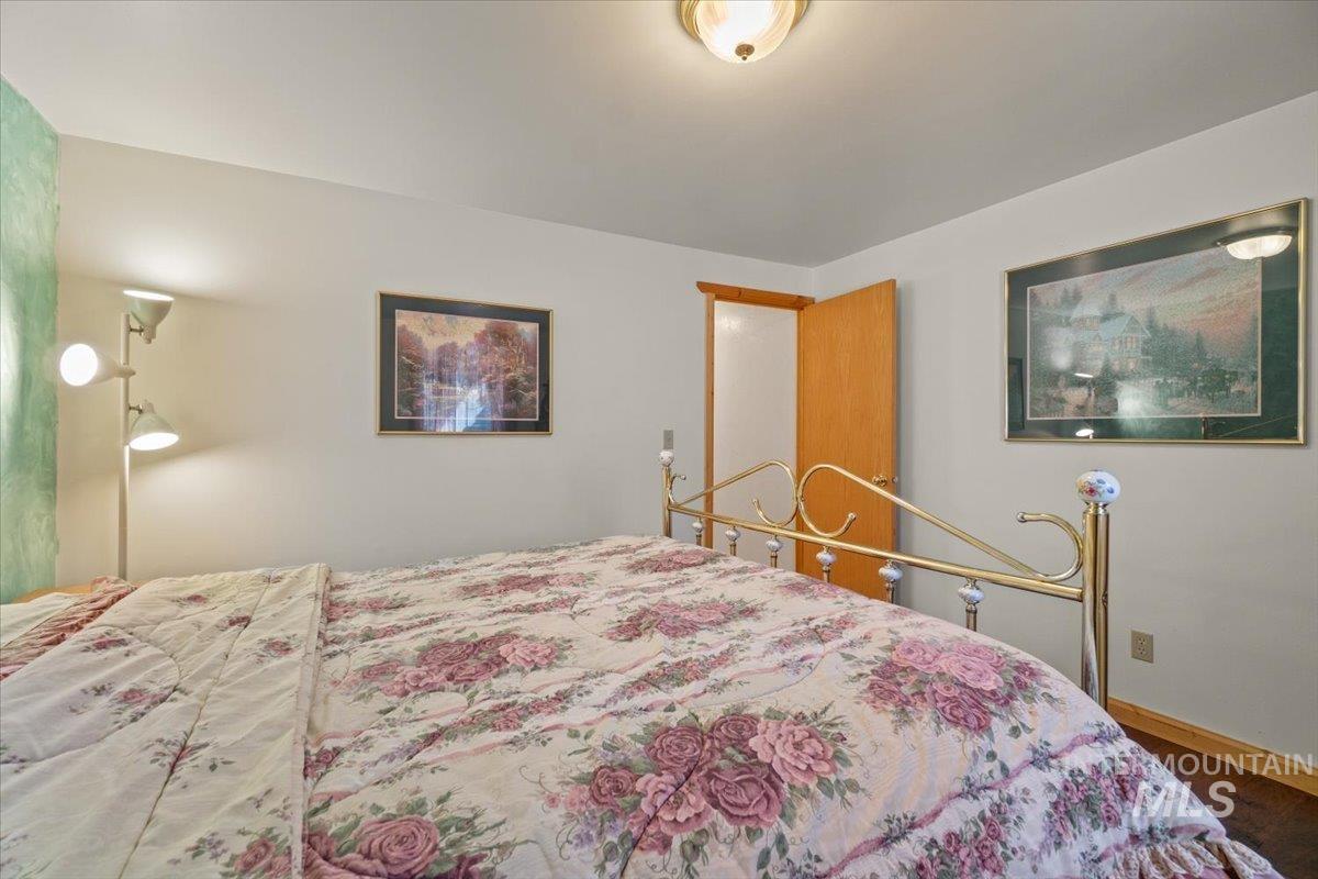 Bedroom featuring baseboards and wood finished floors