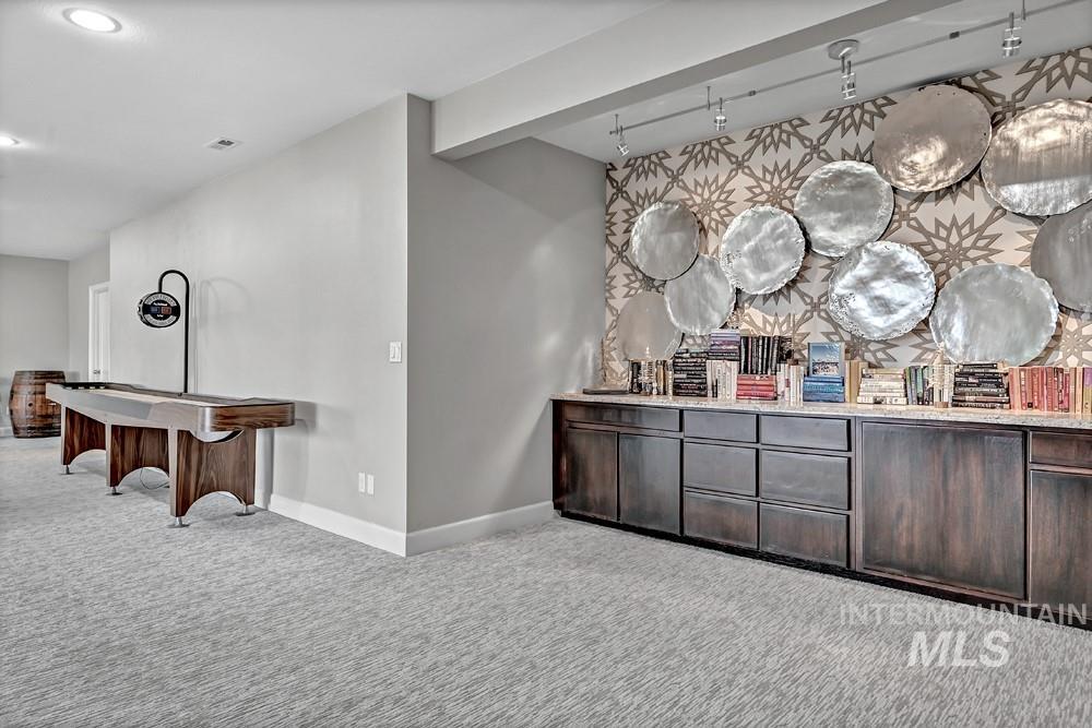 Custom built-in cabinetry with a light-toned countertop, set against a decorative wall with metallic art