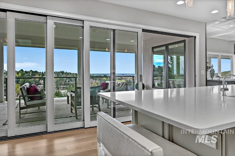 Expansive multi-panel sliding glass doors open to an outdoor patio with a black metal railing